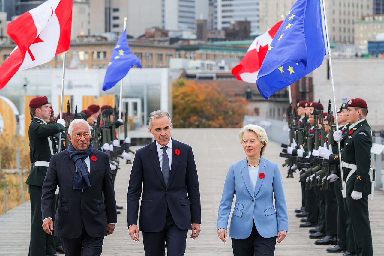 António Costa, Mark Carney and Ursula von der Leyen walk past an honor guard holding Canadian and European Union flags