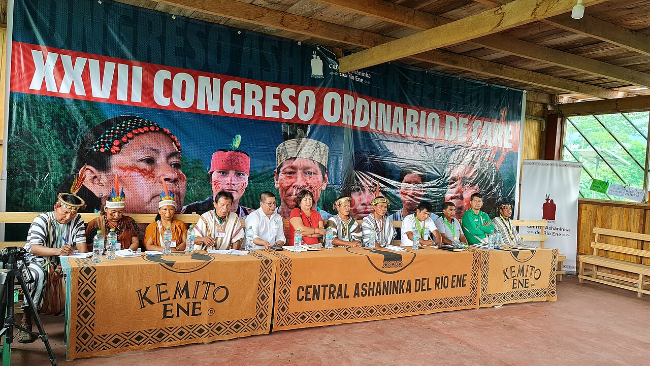 Ashaninka leaders seated at a long table below a banner reading XXVII Congreso Ordinario