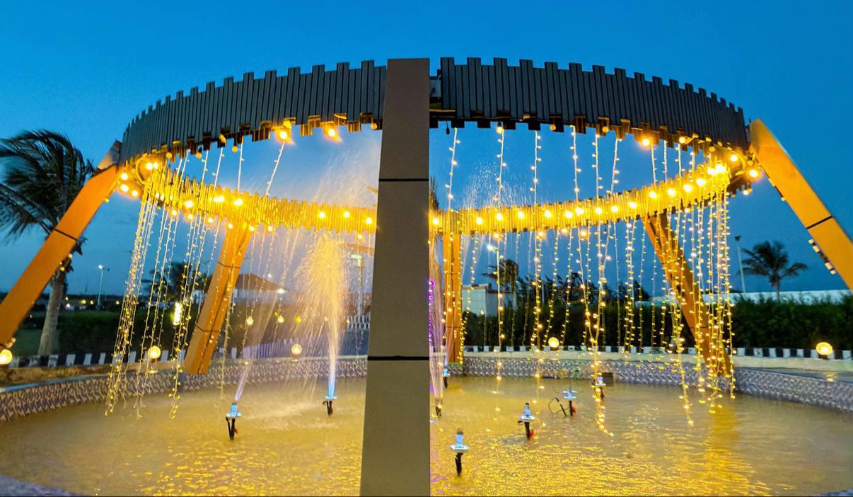 A lit fountain under a ring of lights at dusk in Mogadishu